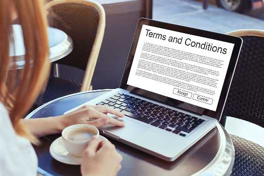 A woman reading the terms and conditions in a laptop